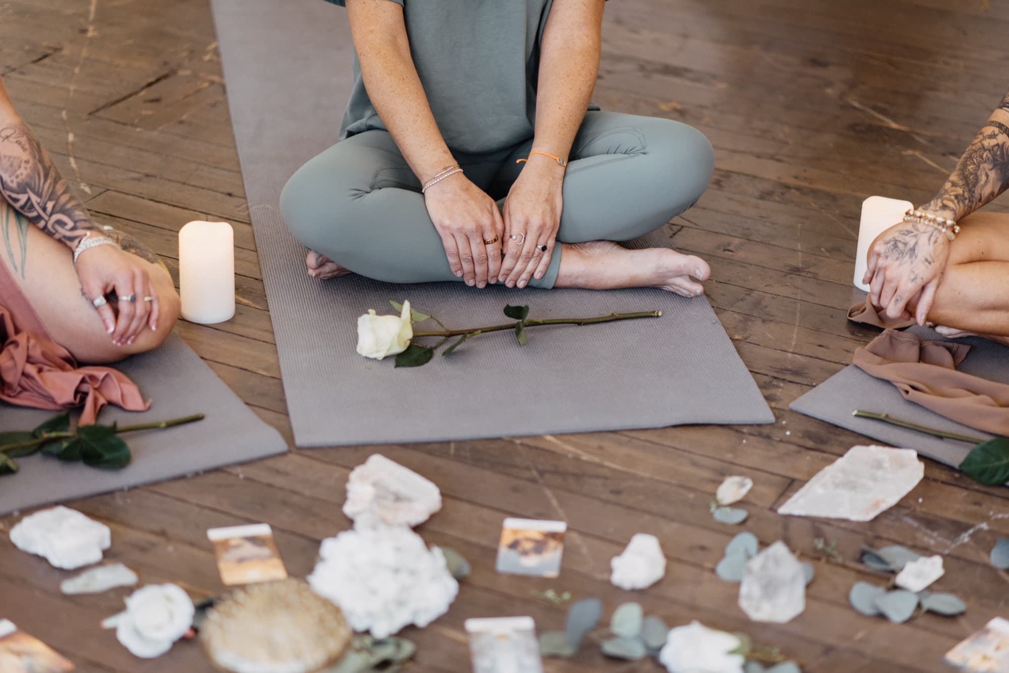 Seated in circle around crystals and candles