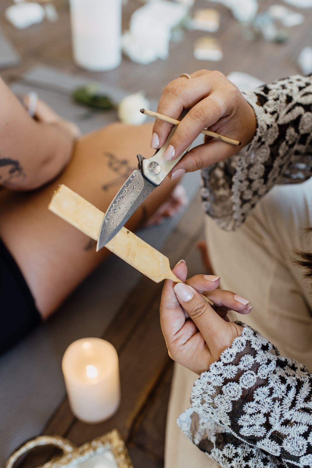 Ceremony tools held over candlelight